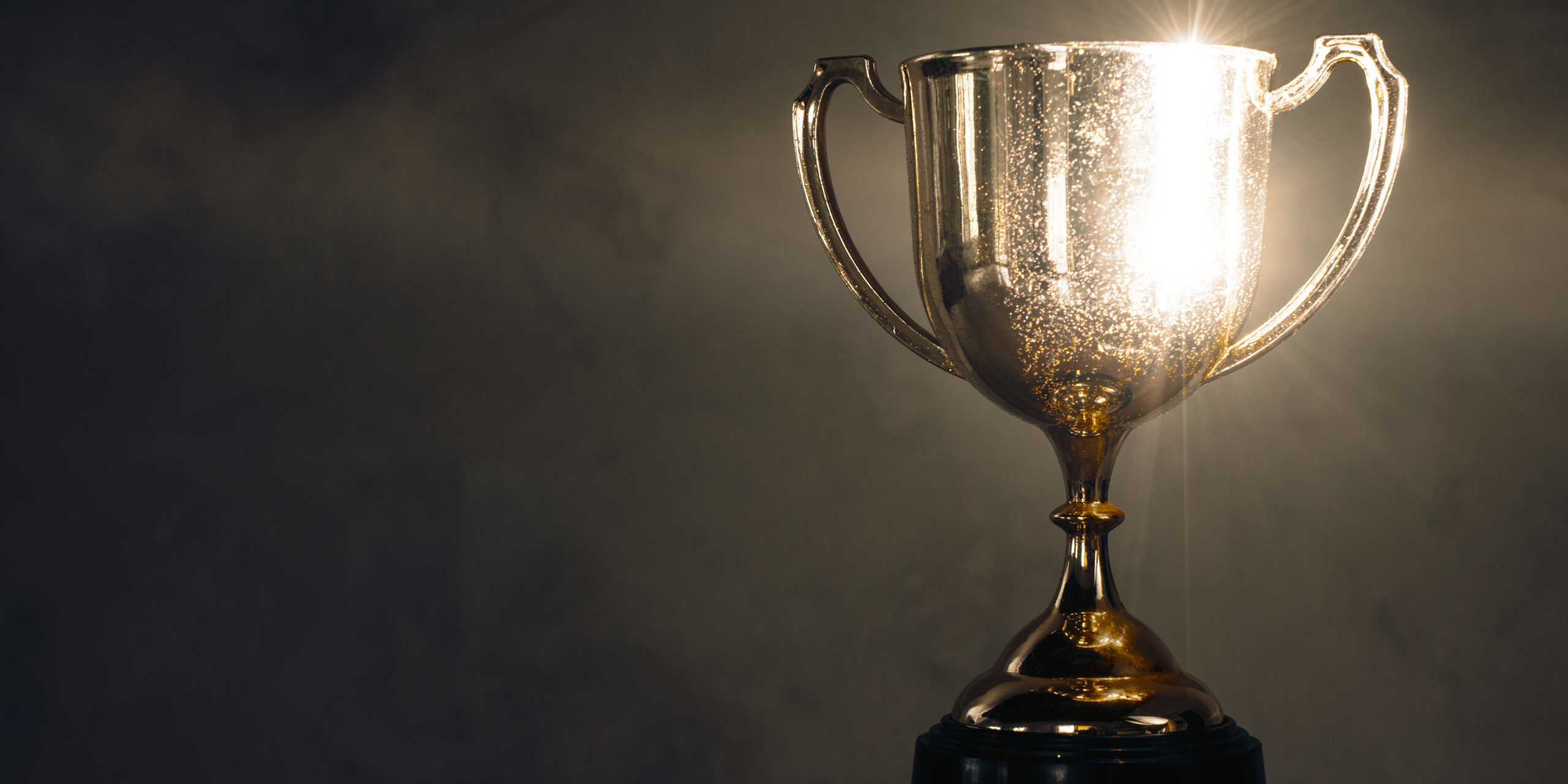 Champion,Golden,Trophy,Placed,On,Wooden,Table